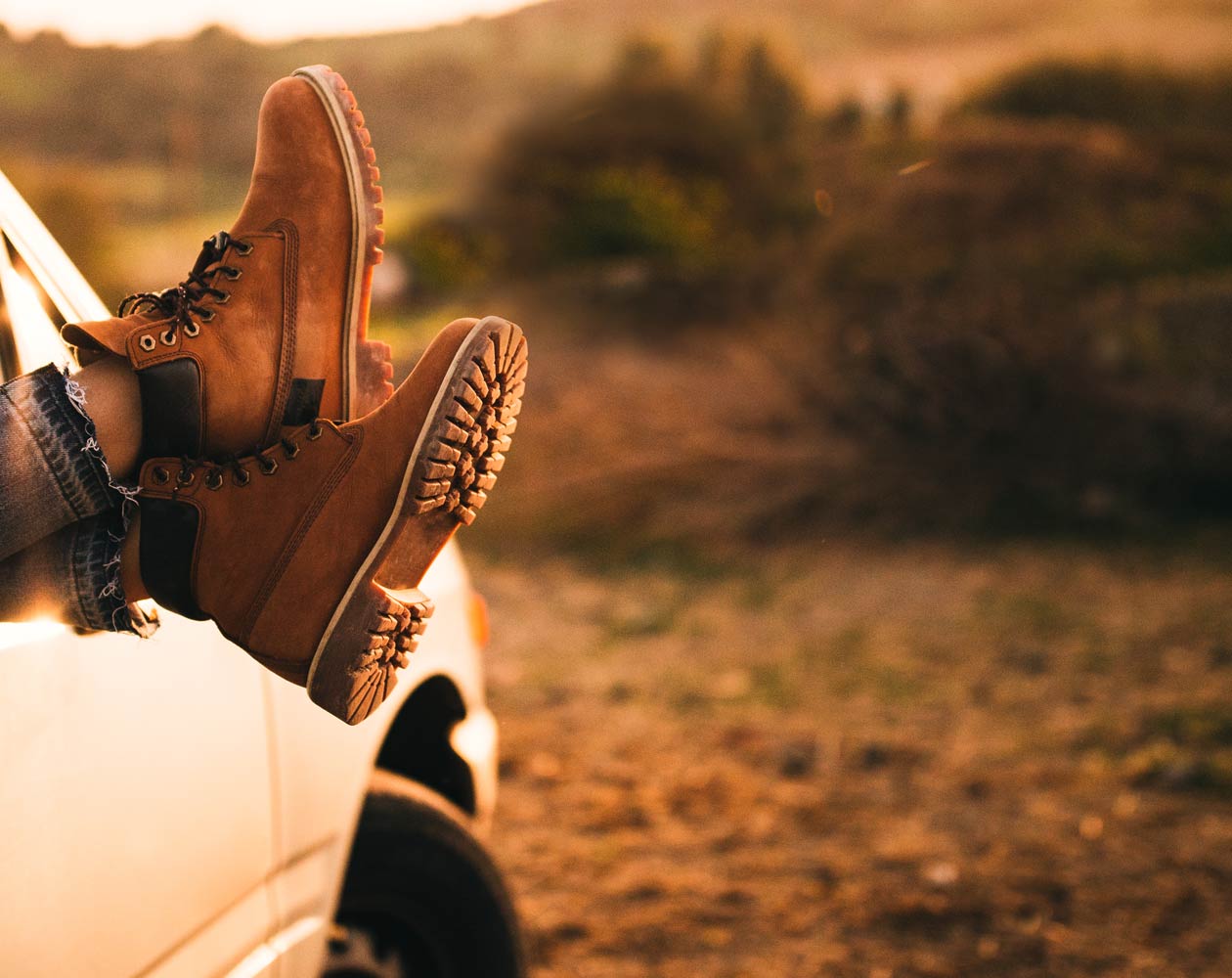 A pair of boots hanging out of the trucks window