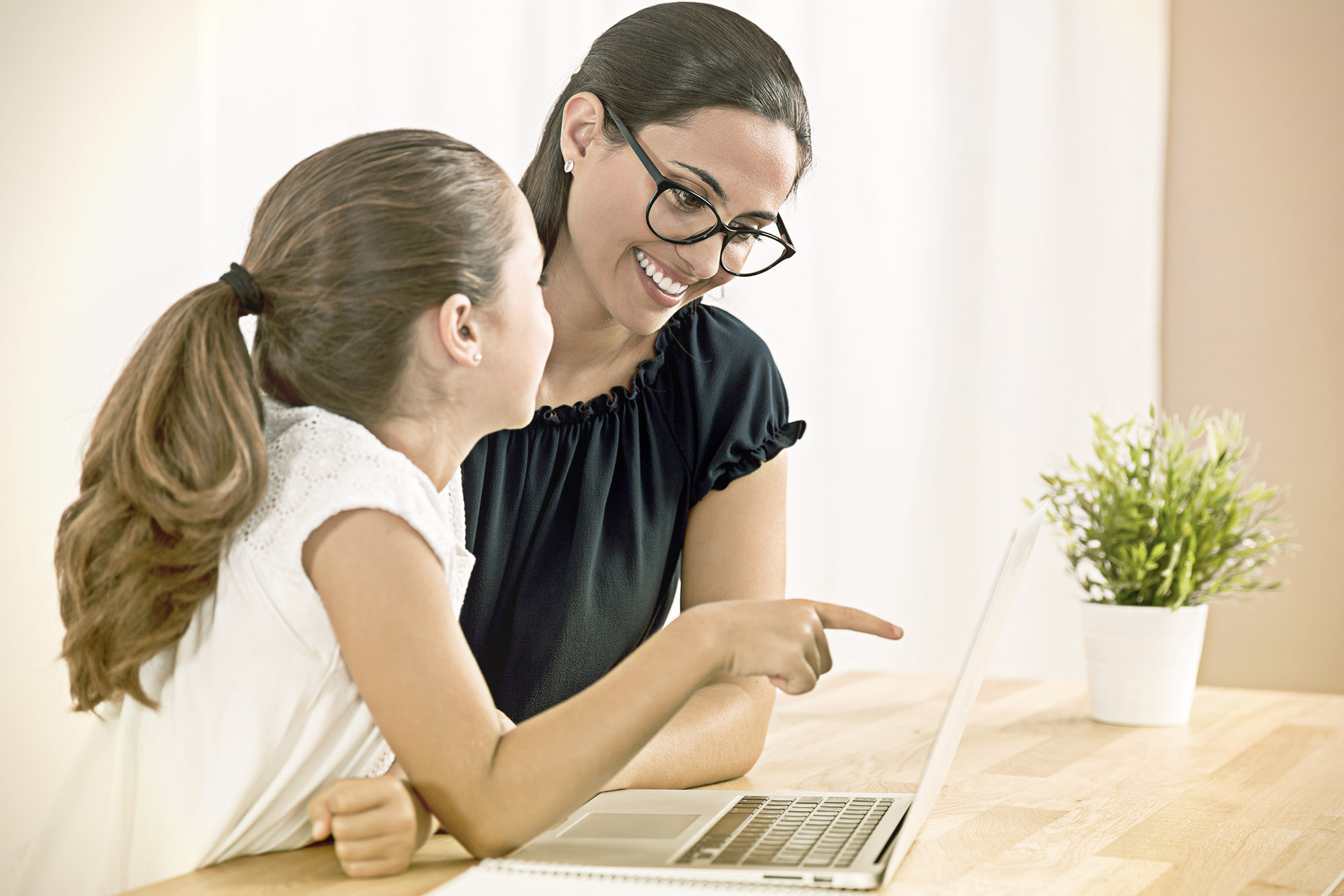 Little girl on her laptop learning financial literacy