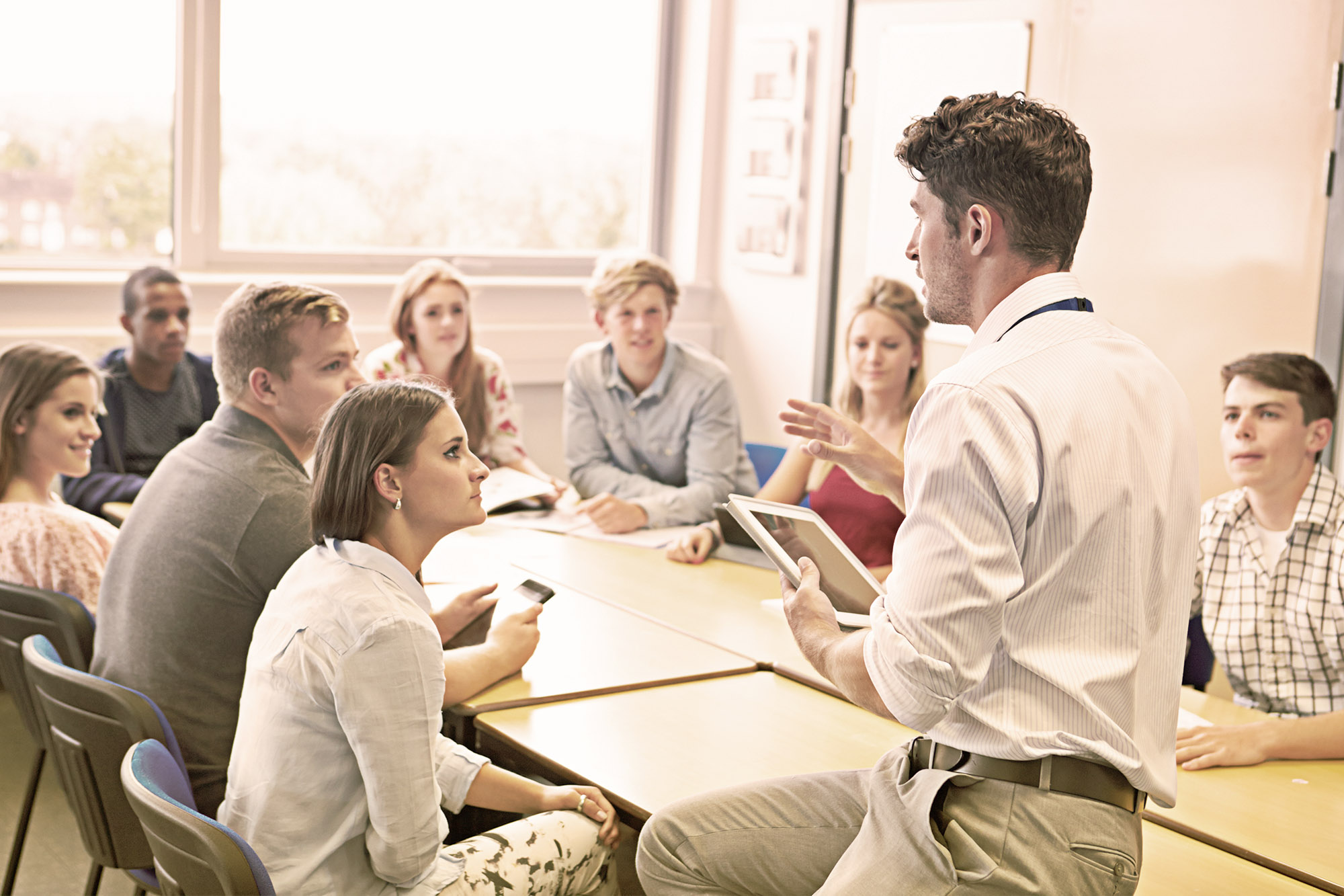 Teacher talking to his class about financial literacy