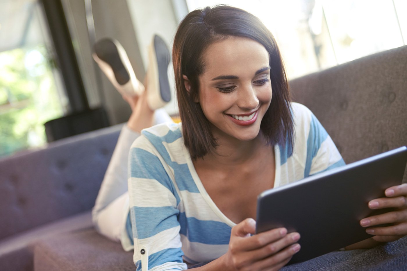 A lady surfing the web on a tablet