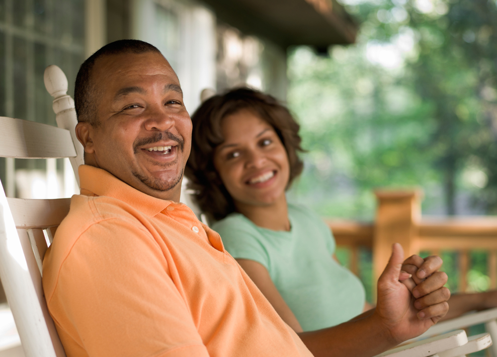 Couple smiling on their front porch