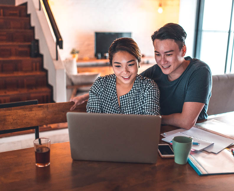 A couple in their home looking over their finances.