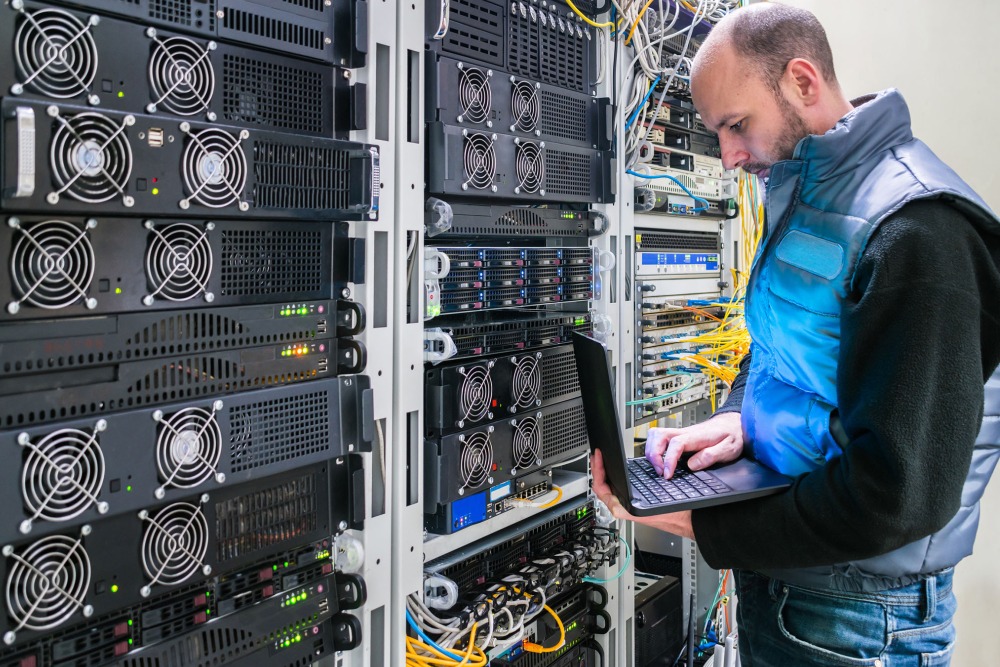 Man with a laptop in the server room